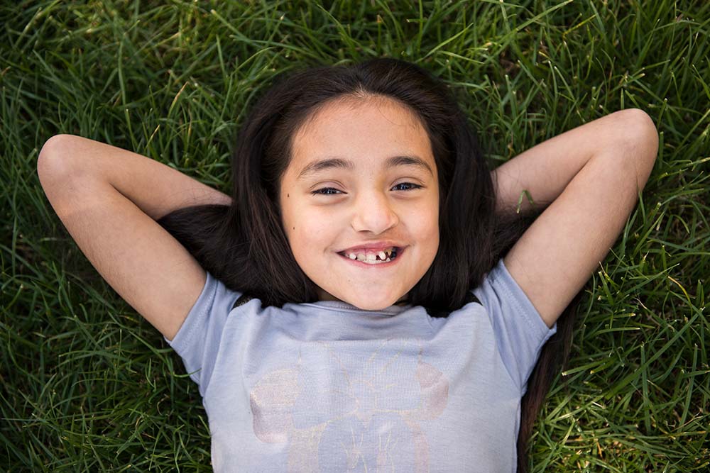 Camila lays on grass