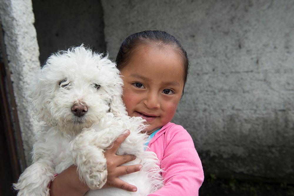 Fernanda holds a dog