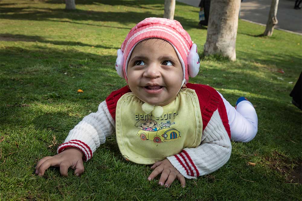 Habeeba crawling with a smile