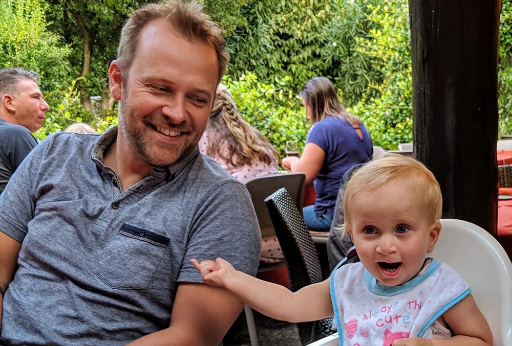 Matilda smiling next to her dad