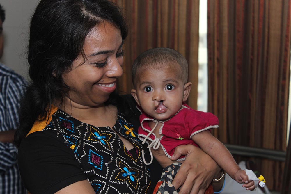 Shakera holds a baby