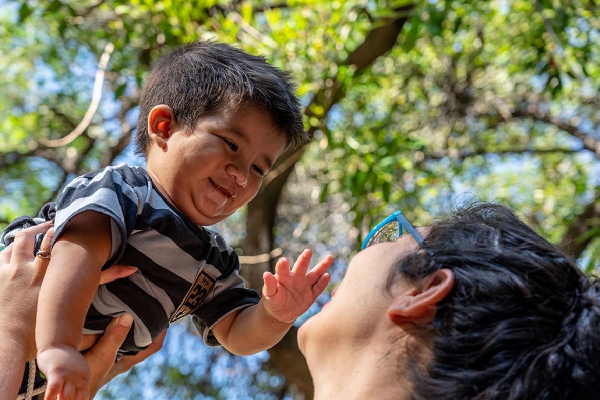 Felix held in the air by his mother