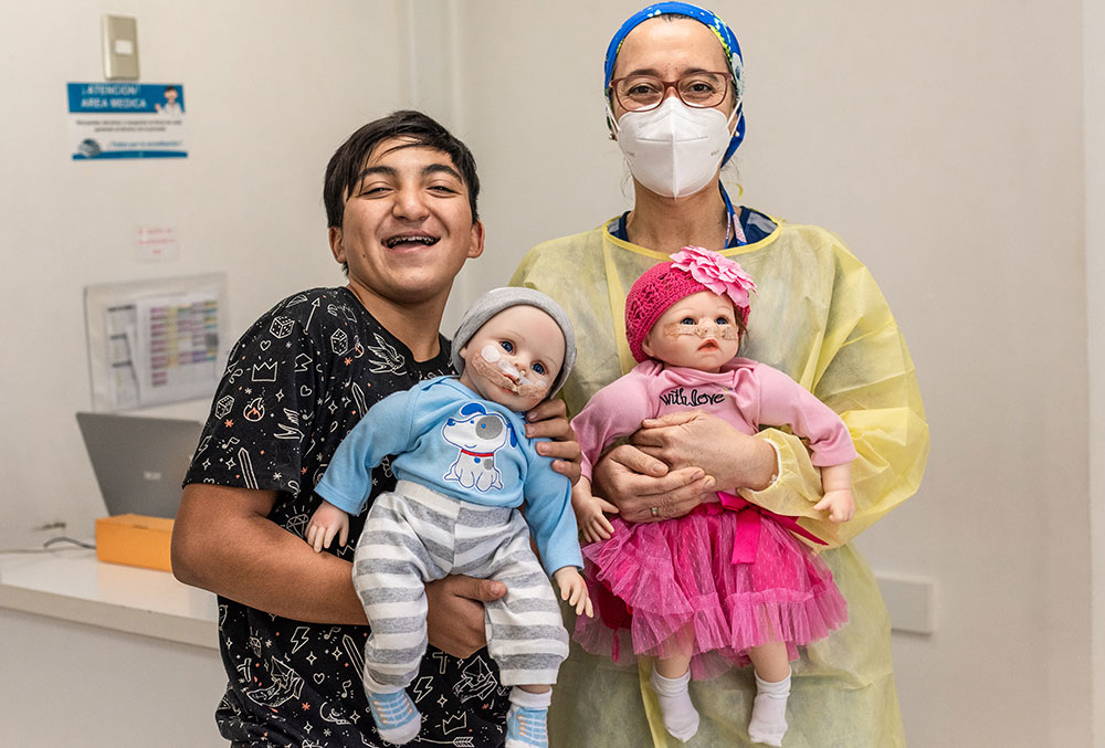 Vicente holds dolls