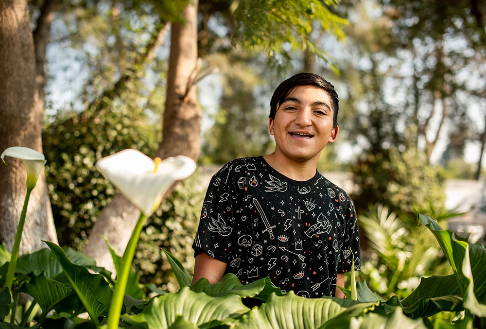 vicente in front of flowers