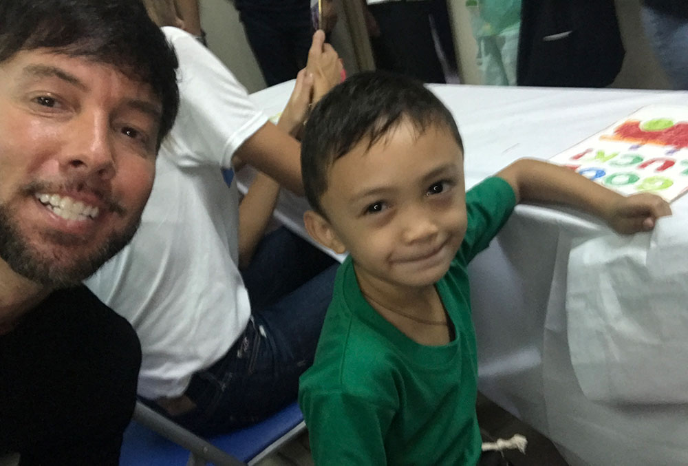 Troy taking a selfie with a patient in the Philippines
