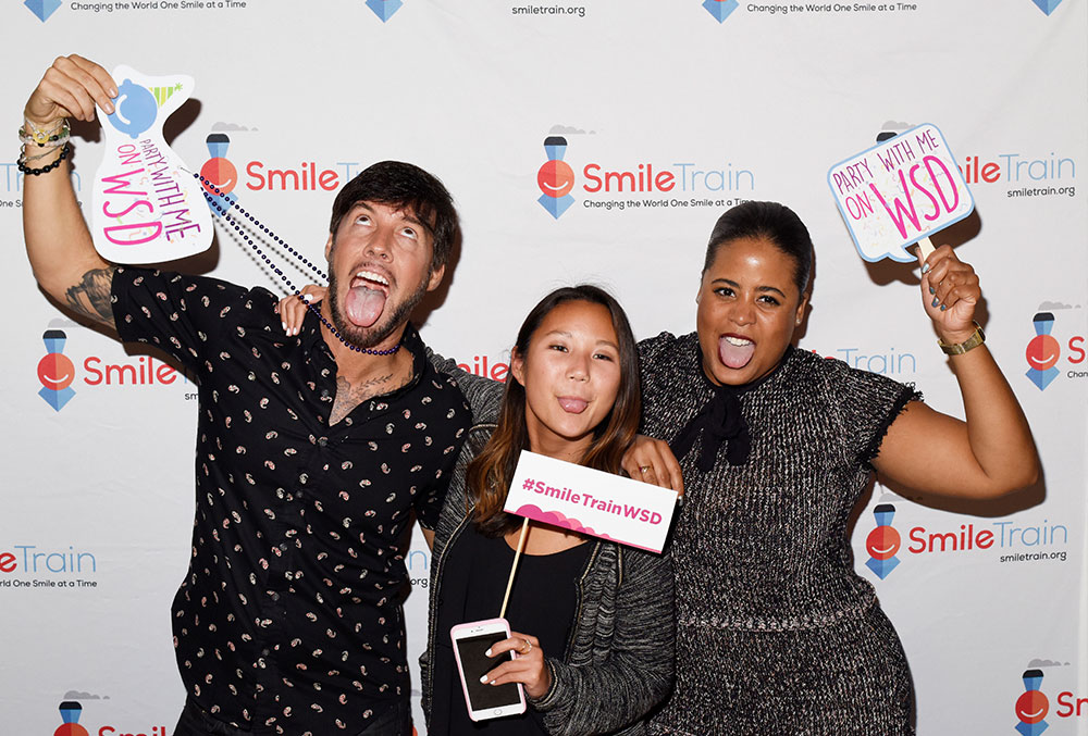 Troy poses with friends and colleagues at a Smile Train World Smile Day(R) event