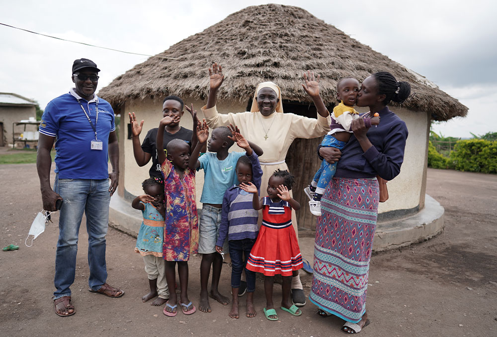 Eric celebrates with his family and Sr. Najjuka