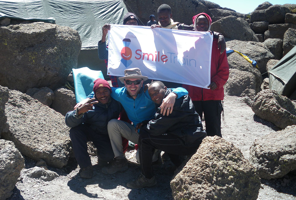 Steve Anthony representing Smile Train on the summit of Mt. Kilimanjaro 