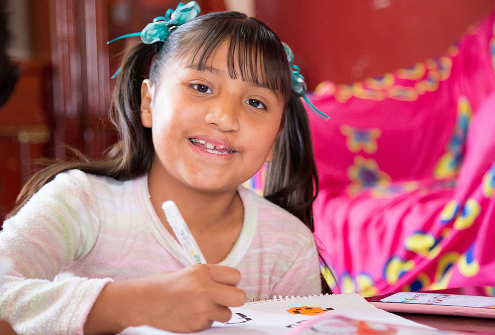 Kendra smiles while coloring