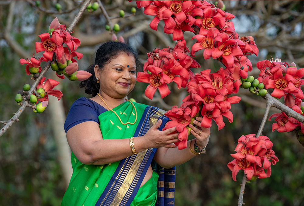 Dr Neela standing amid flowers