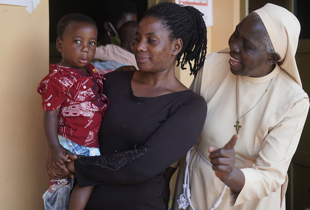 Sister Najjuka with a patient and her mother