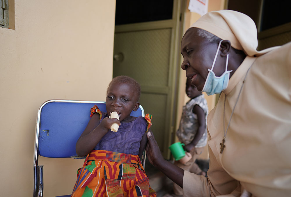 Sister Najjuka providing a cleft patient critical nutritional support