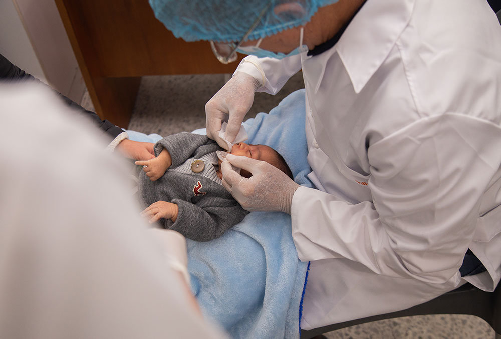 A baby having an impression of their mouth made