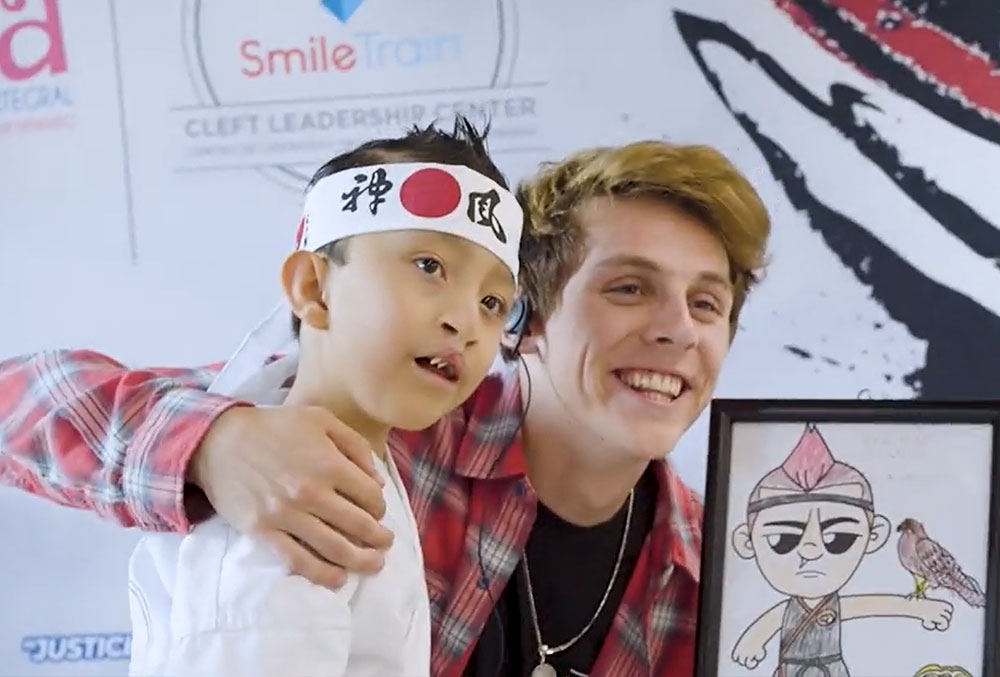 Jacob Bertrand with a patient who drew a picture of him