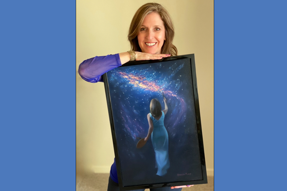 Nanette holding her oil painting Paint the Sky with Stars — one of her several artworks selected to be preserved on the moon
