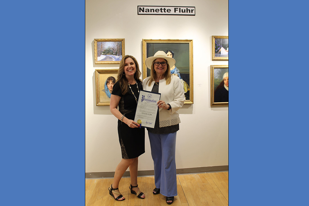 Nanette Fluhr (left) receiving a proclamation for her contribution to the Arts from Legislator and Susan A. Berland