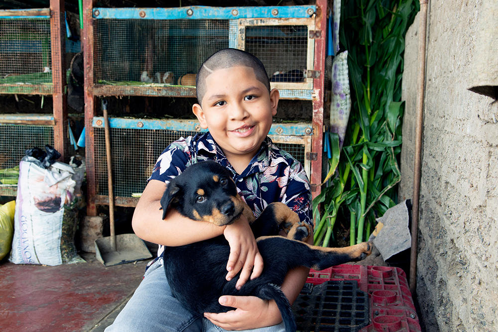 Ramses holding a puppy