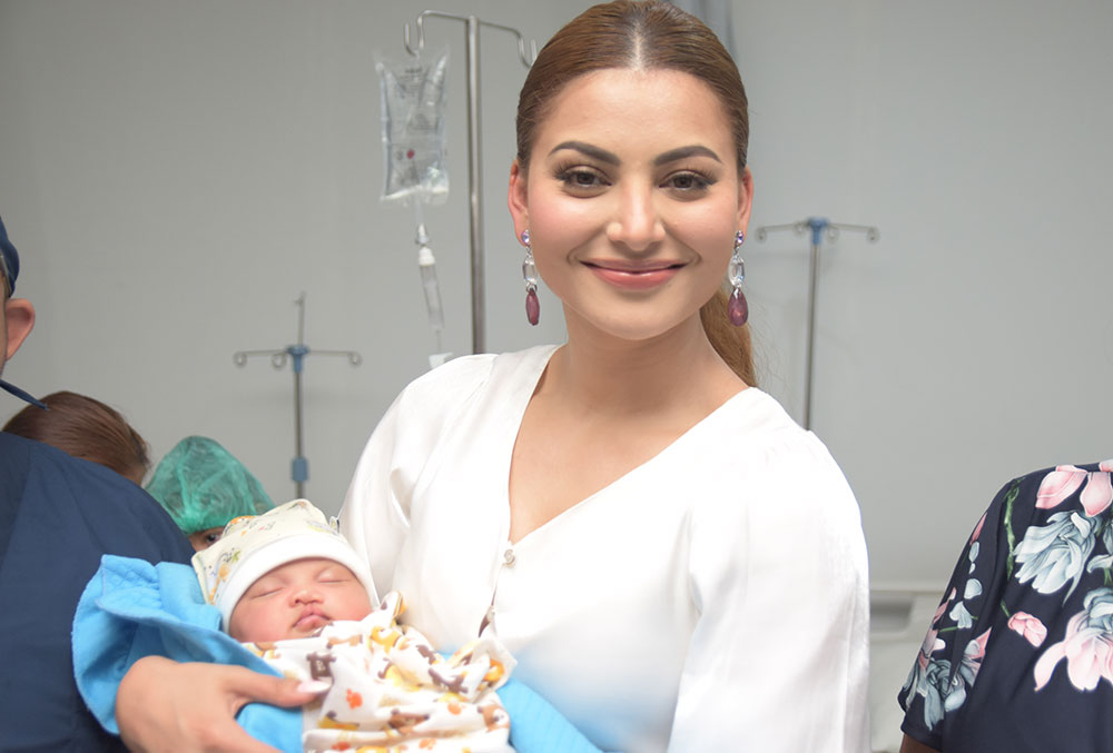 Urvashi Rautela holding a baby