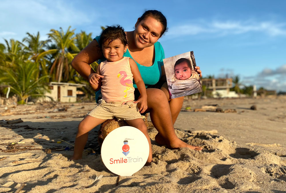 Dani and Maricarmen holding Dani's before picture at the beach