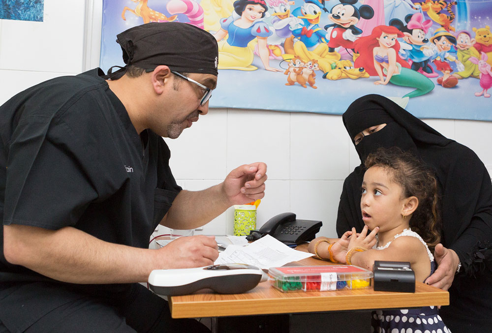Dr. Tarek consults with a patient and her mother
