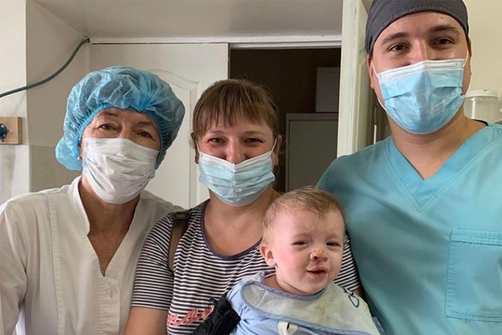 Dr Tetruieva with a young patient and his happy family shortly after his cleft surgery