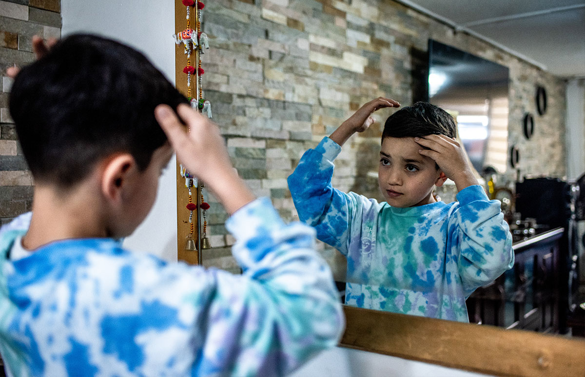 Joaquin doing his hair in a mirror