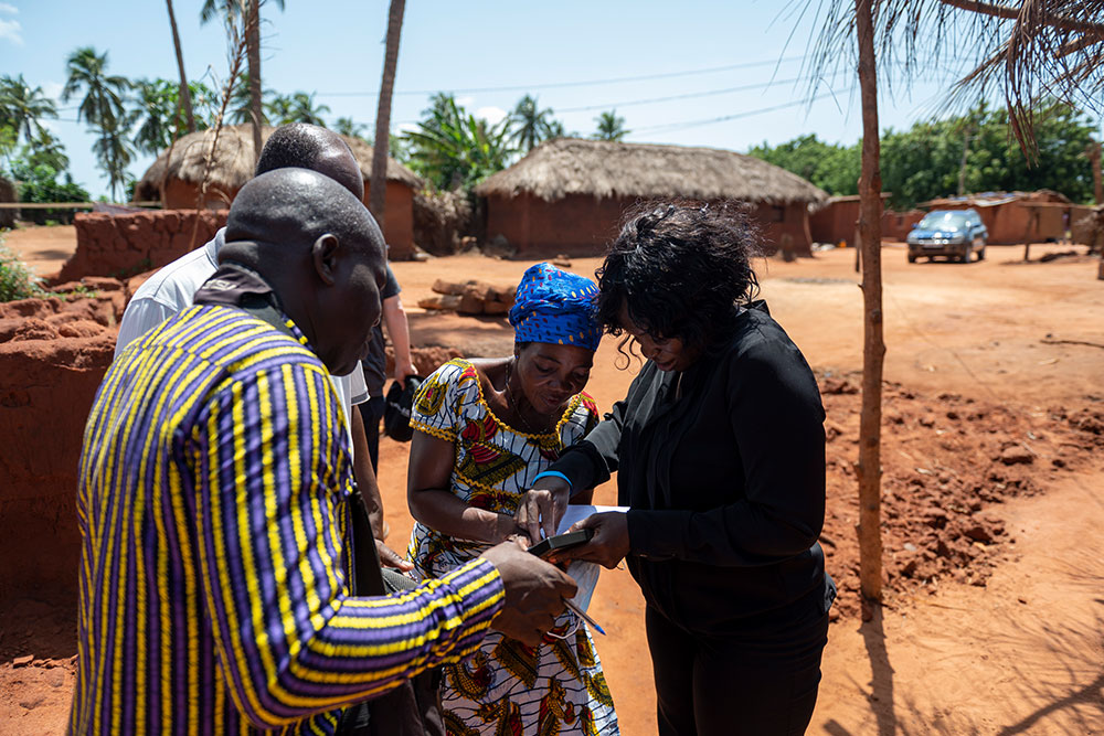 Nina consulting with a patient’s family in a remote village in Togo