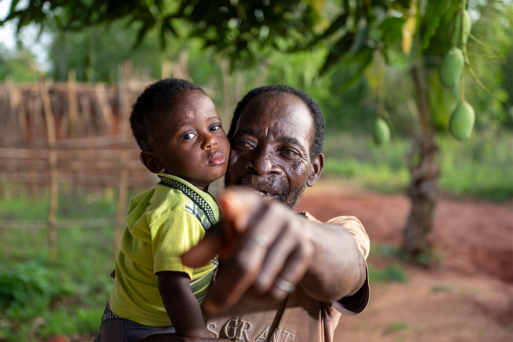 Edoh holding one of his grandsons