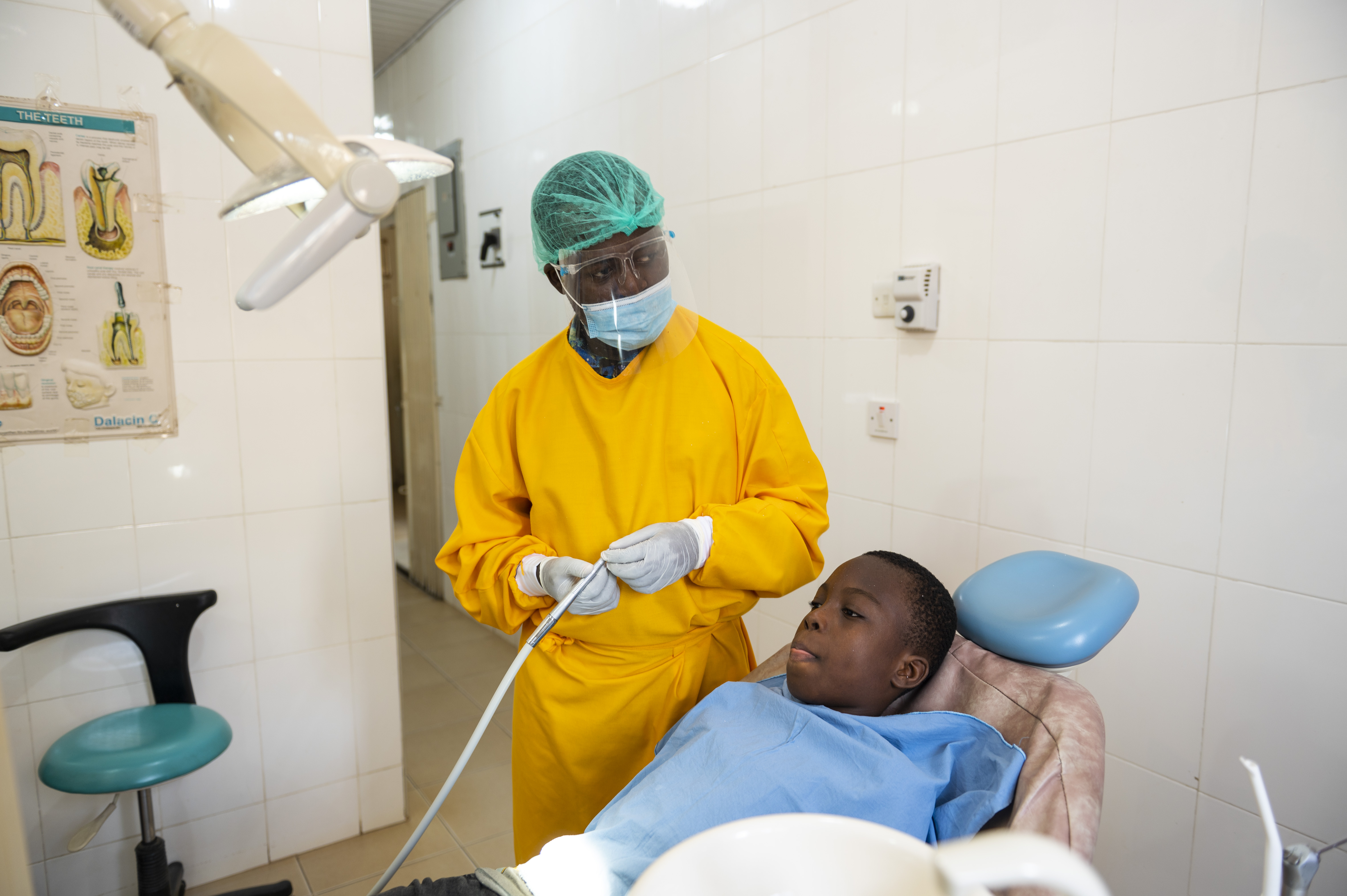 Kelvin in his dentist's office working on a patient