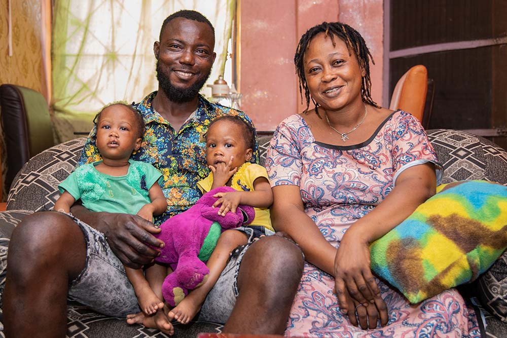 Oloye smiling with her husband and twins after their cleft surgery