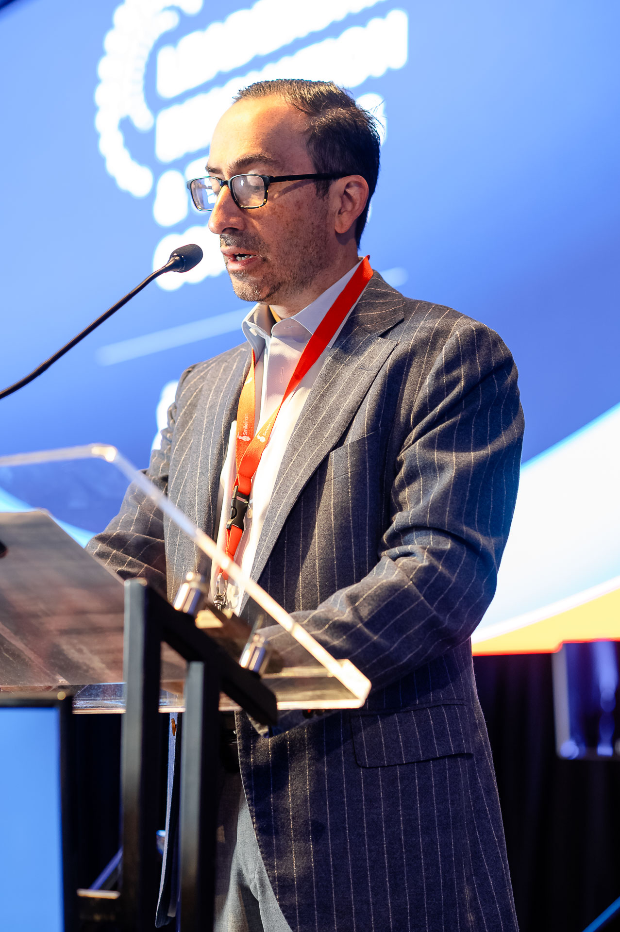 Dr Roberto Flores speaking at a podium