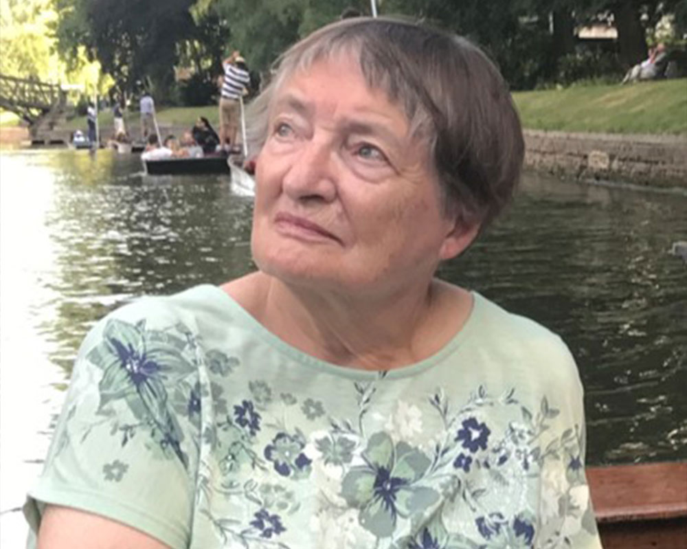 Margaret looking up into the distance on a bridge in Cambridge