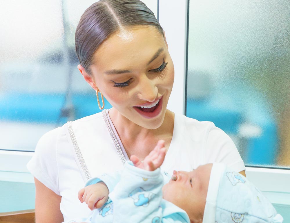 Morgan holding a baby with a cleft