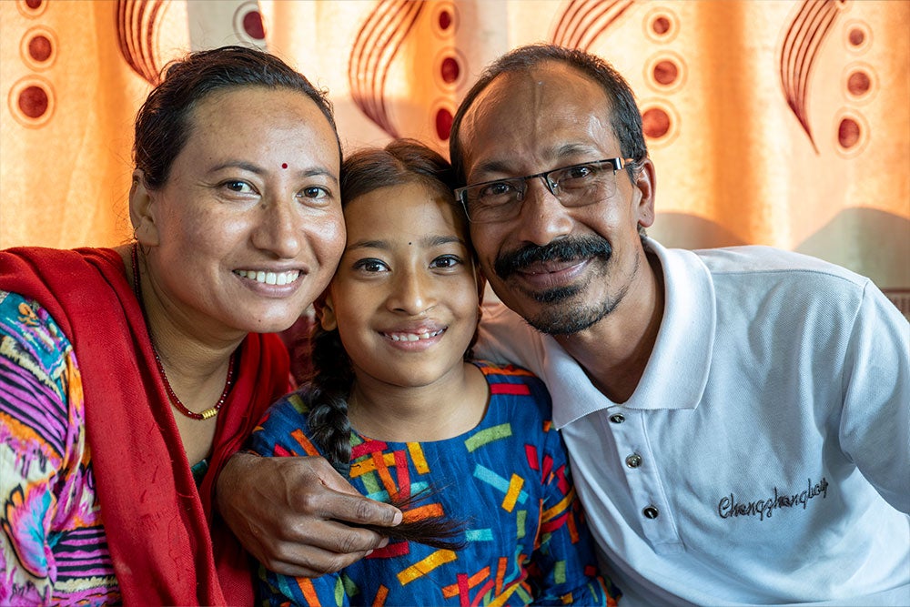 Simrik smiling with her parents