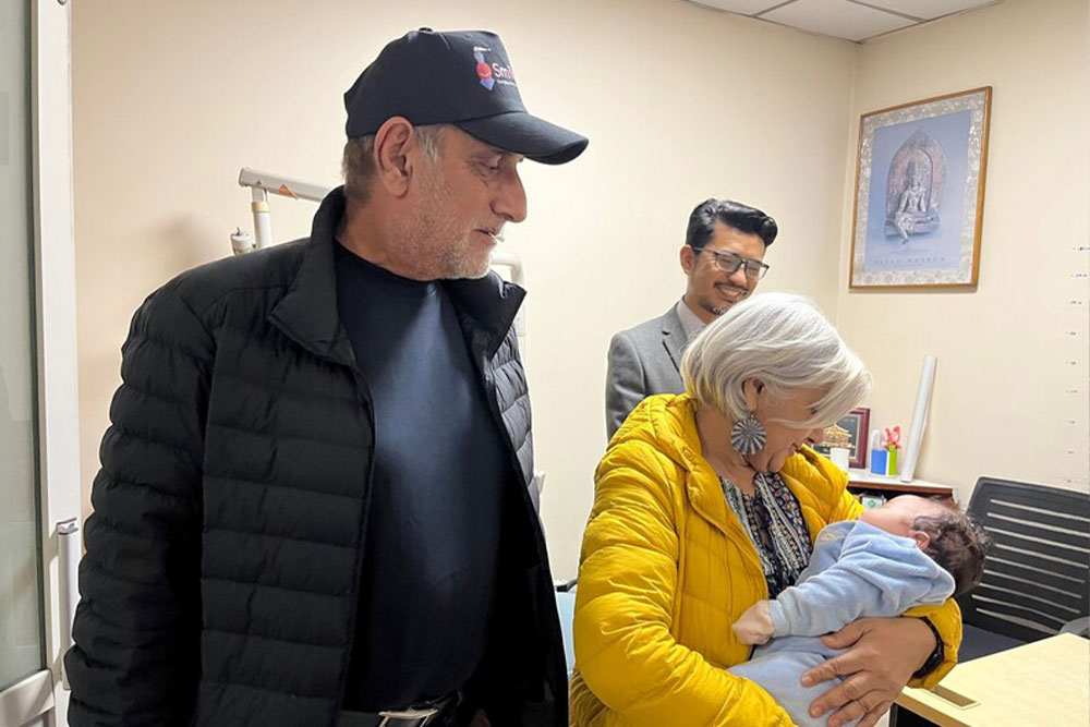 Sunil with his wife, Shikha, as she holds a baby with a cleft at B and B Hospital in Kathmandu