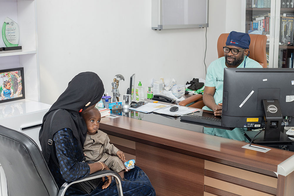 Olanike holding Muaz during a consultation at Grandville Medical and Laser Centre