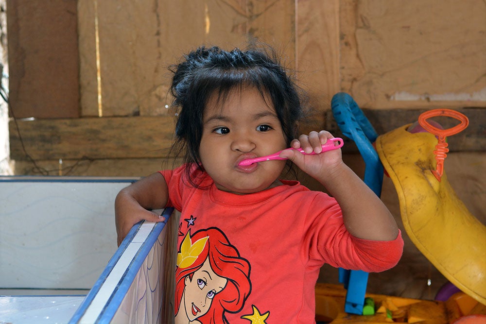 Shaymi brushing her teeth