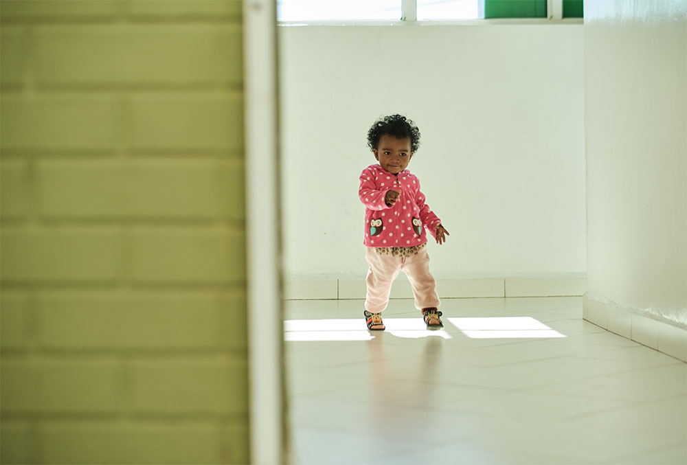 Tsorihasina running down a white hallway after her cleft surgery