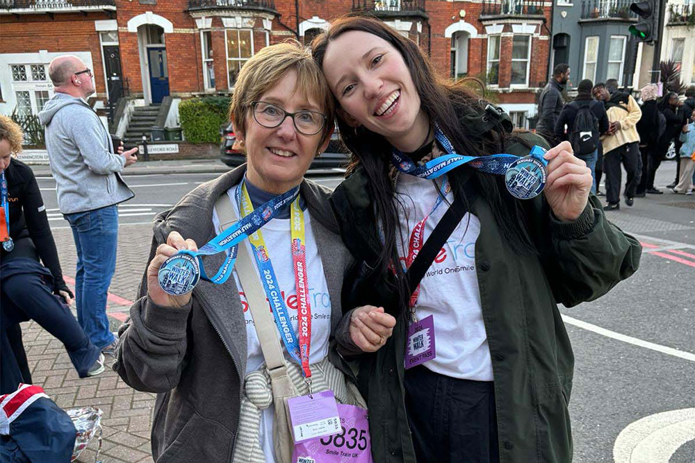 Em and her mother showing off their medals after the Winter Walk