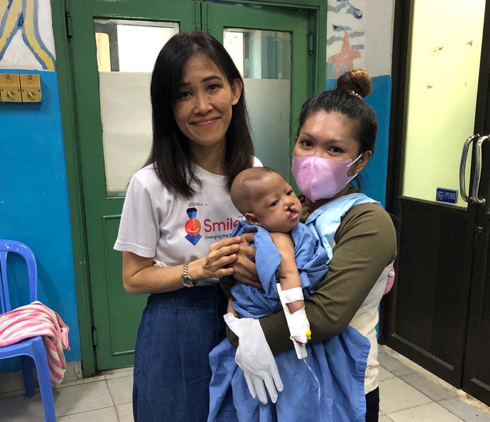 Phensiri in a Smile Train partner hospital with a baby with a cleft and their mother