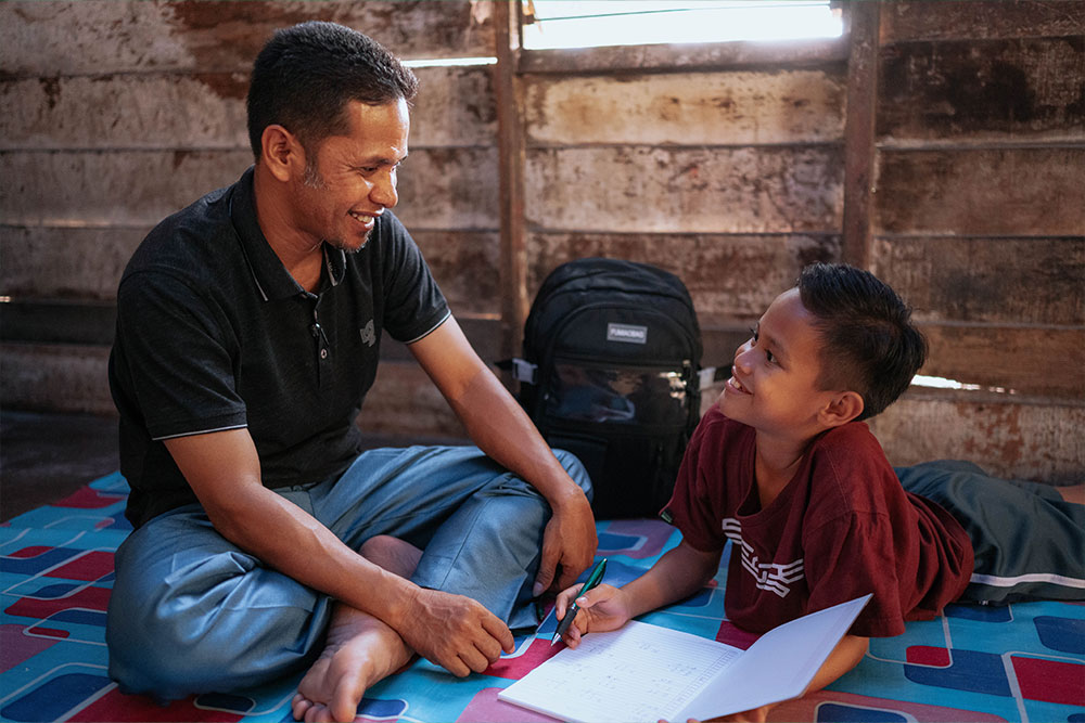 Zafran smiling with this father Yustiwizarto after cleft surgery