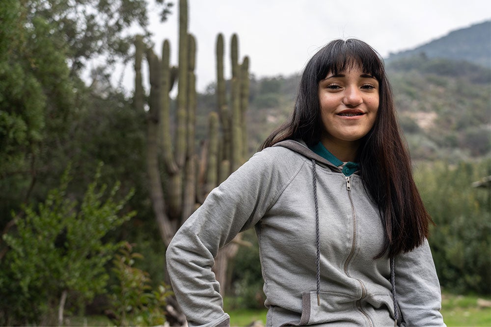 Camila standing before a cactus patch