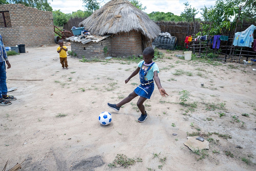 Janerose playing with a football