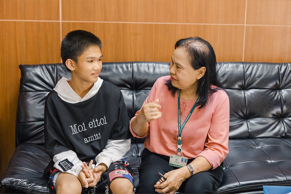 Suteera with a teenage patient