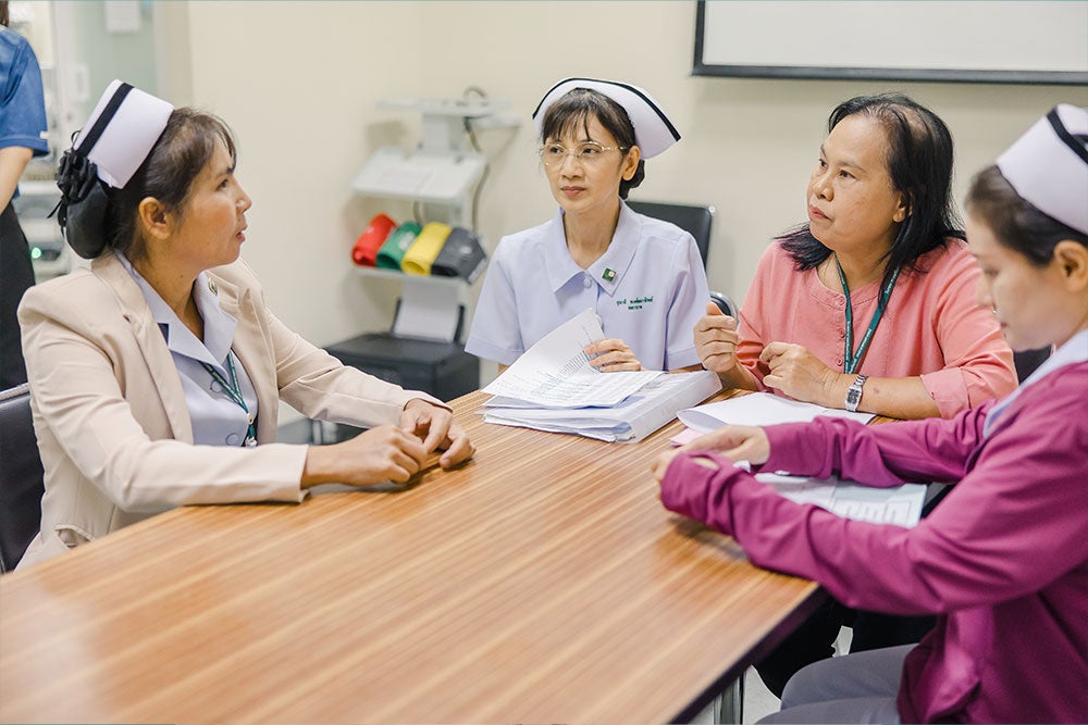 Nurses Yupin and Suteera meeting with other nurses