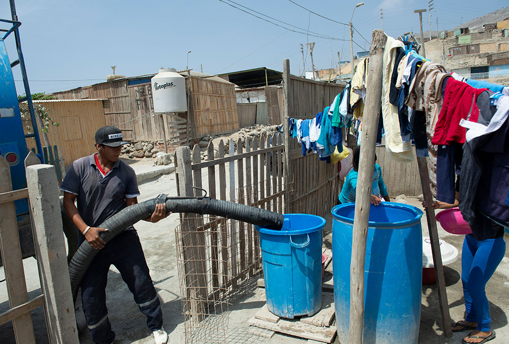 The local water truck driver fills Zindia's tubs