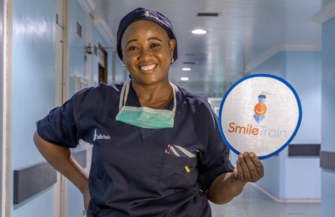 Cleft surgeon from Nigeria holding Smile Train sign