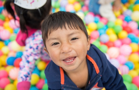 child playing in colorful balls