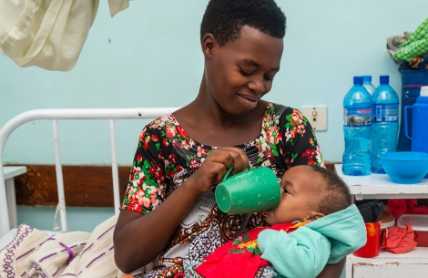 A mother feeding her underweight baby with a cleft in Tanzania