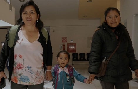 Elsa holding hands with a Smile Train patient and her mother at Fundación Ayninakuna in Sucre, Bolivia